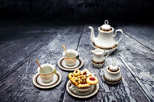 A vertical shot of coffee and tasty cookies on a table - Christmas mood