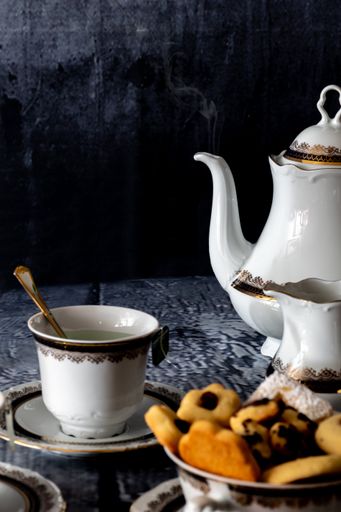 A vertical shot of coffee and tasty cookies on a table - Christmas mood