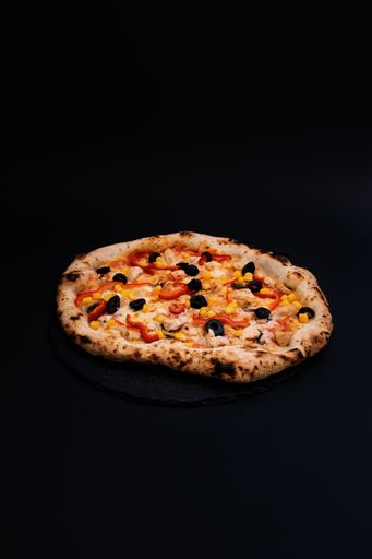 A closeup shot of a tasty looking pizza isolated on a black background