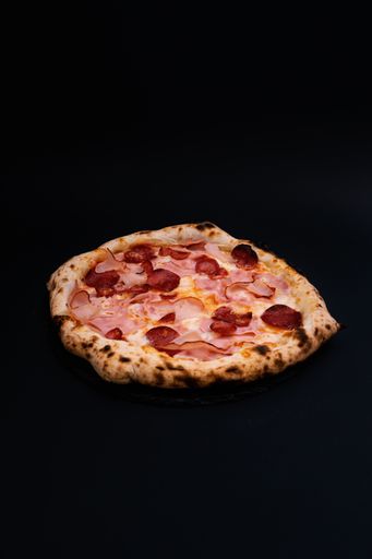 A closeup shot of a tasty looking pizza isolated on a black background