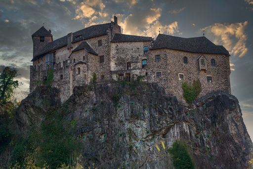 A low angle shot of the Roncolo castle on a cliff in South Tyrol
