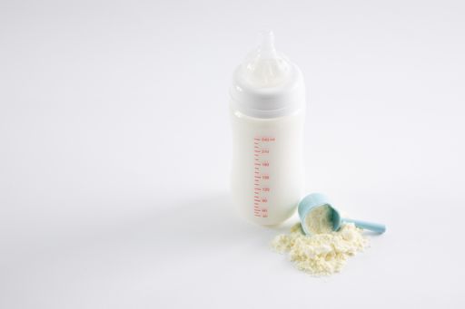 A closeup shot of a feeding bottle and baby food