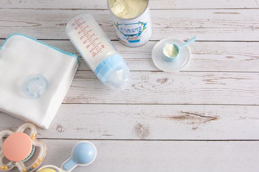 A top view of baby products on a wooden surface with space for text