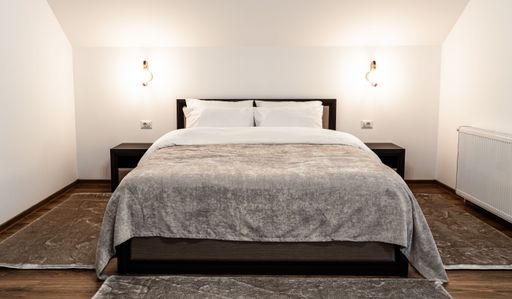 A nicely furnished bedroom Inside of a modern house in minimalistic style