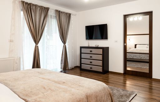 A nicely furnished bedroom Inside of a modern house in minimalistic style