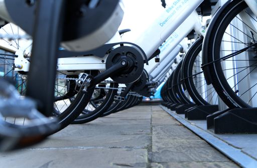 A closeup shot of a row of rental bicycles at the bicycle parking
