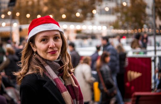 Picture of Christmas Portrait of 30's Slavic Woman in Santa Claus Hat and Skating Rink with Beautiful Lights in the Background. Lifestyle Concept