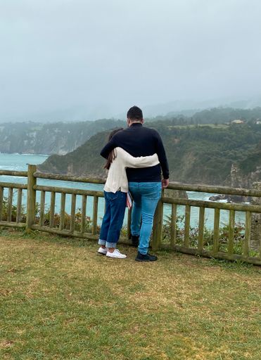 A vertical shot of a love couple in Ermita de la Regalina, Asturias, Spain