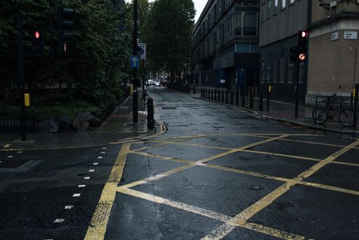 An empty wet street near apartment buildings in London, England