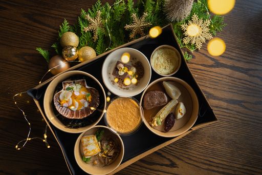 A top view of appetizing food with christmas decorations on a wooden table