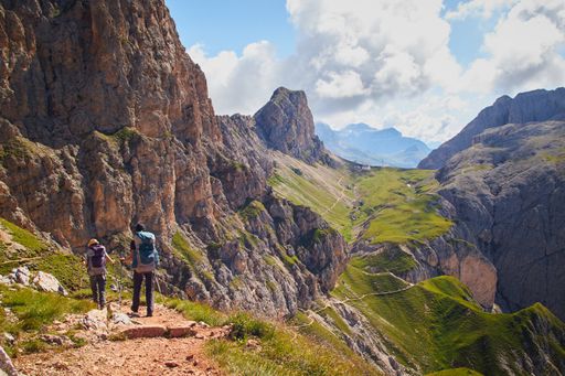 A group of people hiking in the mountains of Schlern-Rosengarten Nature Park  in Italy