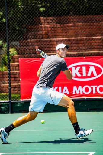 Johannesburg, South Africa - November 10, 2012: Amateur male tennis player practicing on a sunny day