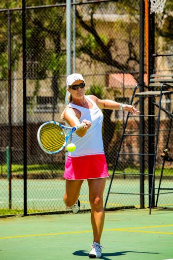 Johannesburg, South Africa - November 10, 2012: Amateur female tennis player practicing on a sunny day