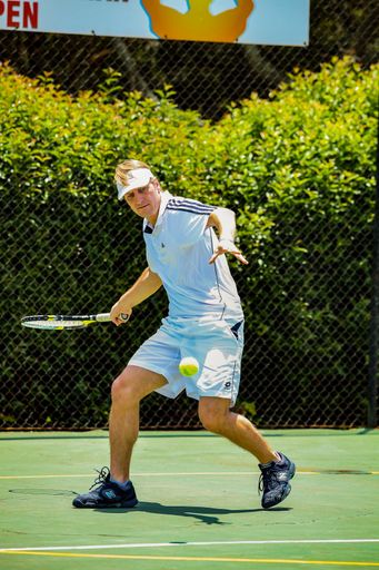 Johannesburg, South Africa - November 10, 2012: Amateur male tennis player practicing on a sunny day