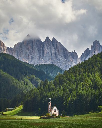 A vertical shot of a lighthouse in the Puez-Geisler Nature Park in Italy