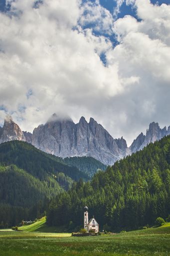 A vertical shot of a lighthouse in the Puez-Geisler Nature Park in Italy