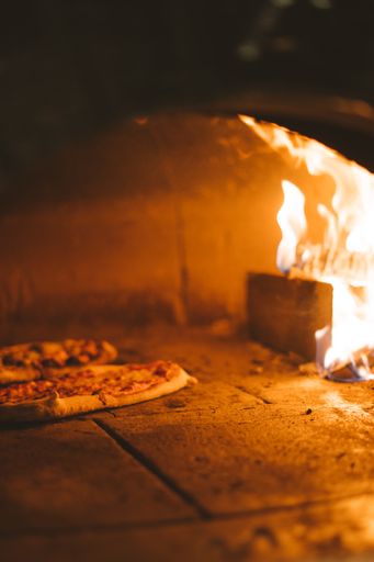 A vertical shot of bread dough near the fire in the stove