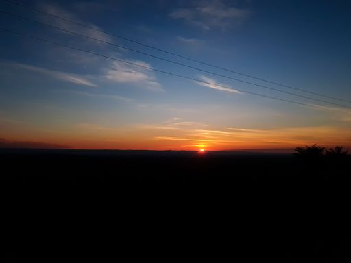 Orange sunset with clear cky. Large horizon. Open field