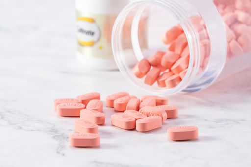 A selective focus shot of medicine pills in a transparent bottle