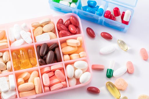 A top view of different medicine in a container isolated on a white background