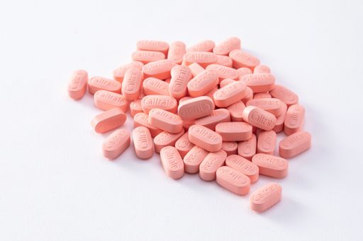 A closeup shot of many calcium tablets Caltrate isolated on a white background