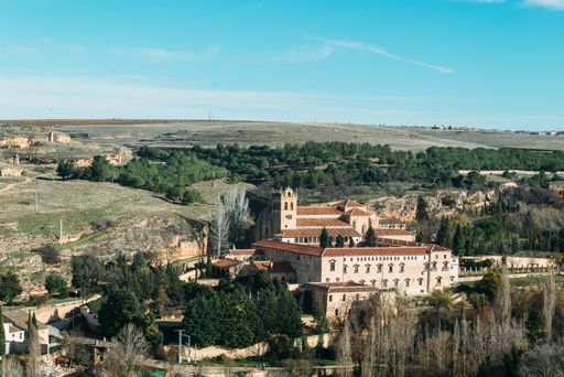 A high angle shot of the beautiful old buildings among the trees captured in Segovia, Spain