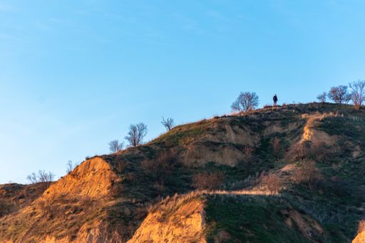 The rocky hills against the blue sky during sunset