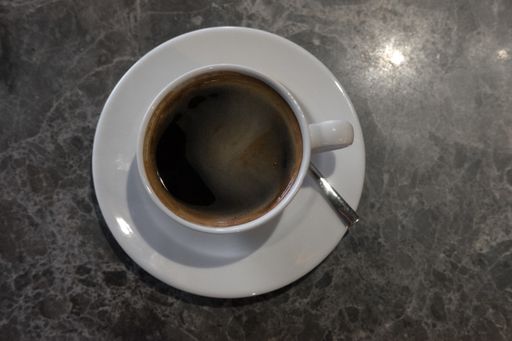 A top view of a cup of coffee on blurred background