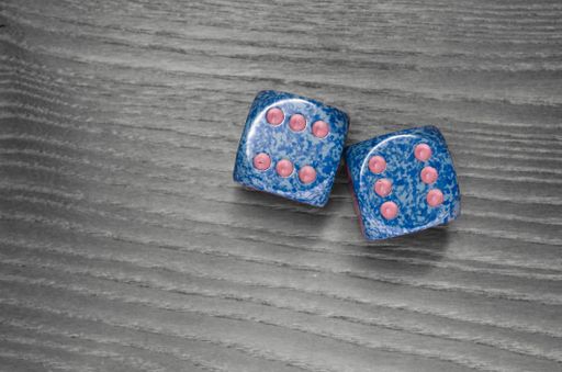 An overhead shot of two dice on a wooden surface
