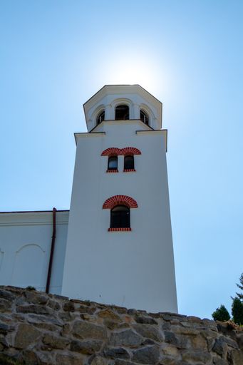 A vertical low angle shot of a monastery in Bulgaria under the sunlight in a clear blue sky