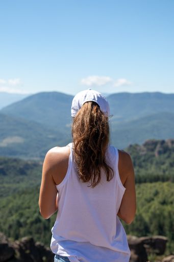 A back view of a young woman with cap in Belogradchik, Bulgaria