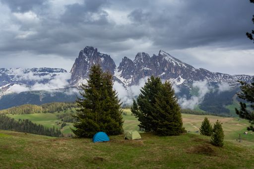 The two tents on the Seiser Alm Alpine meadow with the Langkofel group in Italy