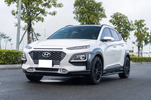 A white Hyundai Kona car on the asphalt road