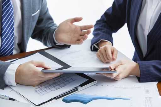 Two businessmen in elegant suits at a business meeting discussing a new project in the office
