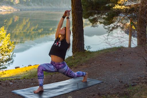 An attractive Caucasian woman practicing yoga surrounded by beautiful nature scenes