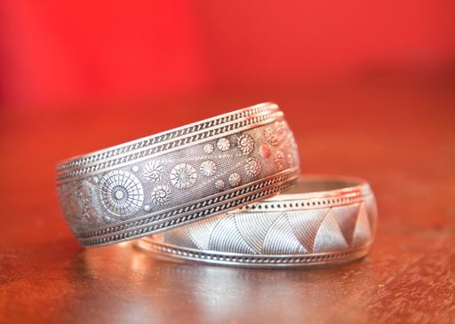 A closeup shot of old vintage silver rings on a wooden table