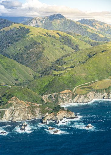 An aerial shot of a beautiful grassy mountain range in California, United States