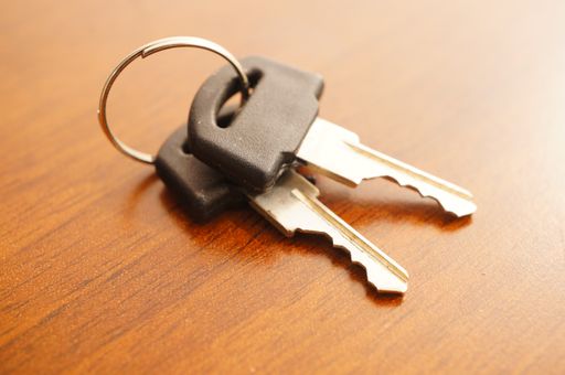 A closeup shot of two identical keys on wooden background