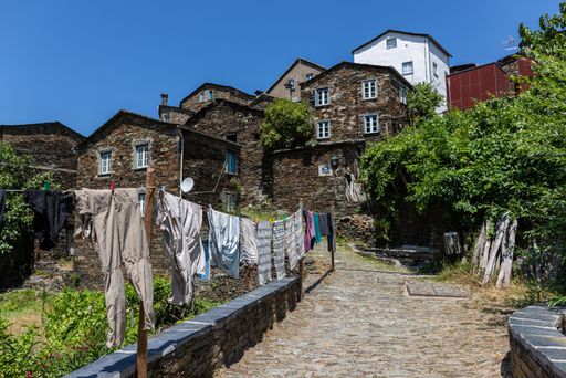 The village Piodao surrounded by greenery and stone buildings under sunlight in Portugal