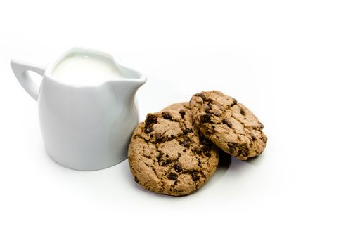 The delicious cookies with a fresh cup of milk on a white background
