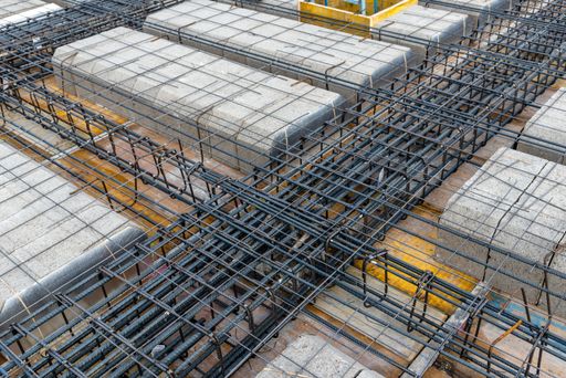 Construction site with steel formworks and reinforcing bars for pillars ready for concrete pouring