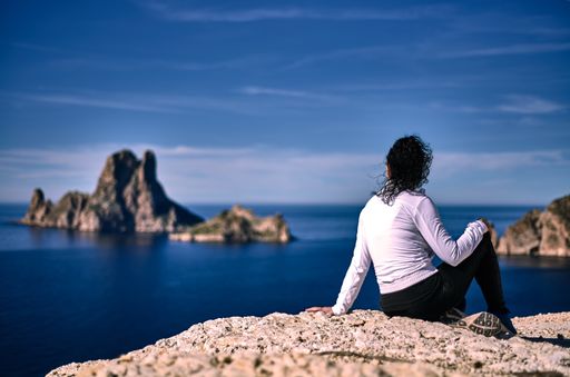 A female hiker enjoying a beautiful view from a cliff