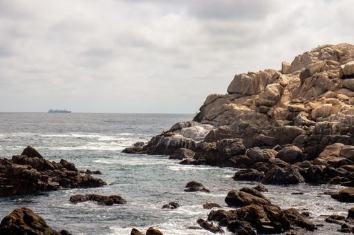 A mesmerizing shot of a rocky seashore under a cloudy sky
