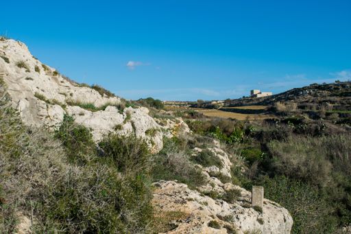 Countryside and agricultural land views along the hills of Malta, photographed from Victoria Lines, Rabat on a sunny autumn day, with blue sky.