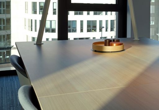 Empty office conference table with office building in the background