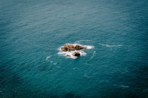 Aerial view of dramatic seascape featuring waves crashing against rocks on the Atlantic Ocean at Cabo da Roca in Portugal