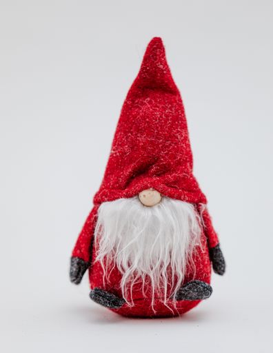 A cute Christmas toy in the shape of a soft red gnome