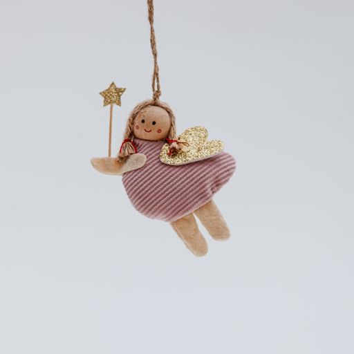 A funny soft Christmas toy in the shape of a little girl angel with a magic stick