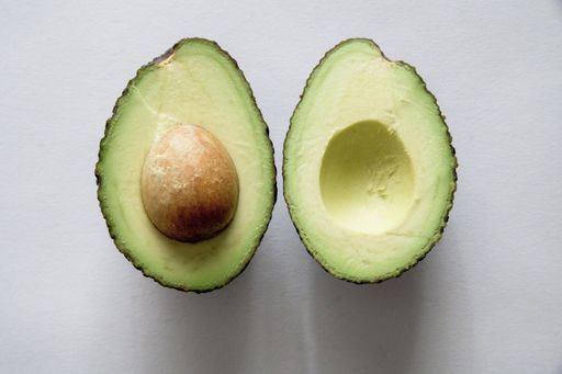 A high angle shot of fresh delicious avocado on a white surface