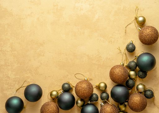 A beautiful Christmas corner background with gray and brown balls on a soft beige surface with a copy space